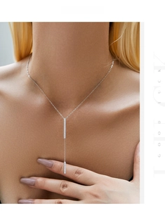 Detail of silver S925 Y-necklace with micro-pave zircon vertical bar pendant on model