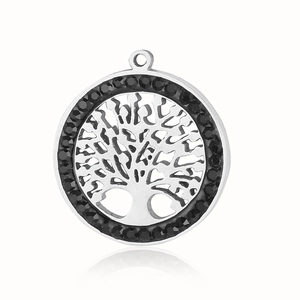 Macro shot of silver stainless steel pendant featuring a hollow tree of life and black gems