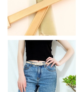 Detail of gold metal spring belt and model wearing slim beige elastic waist strap