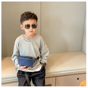 Blue denim waist bag for kids styled with casual grey hoodie and trendy sunglasses
