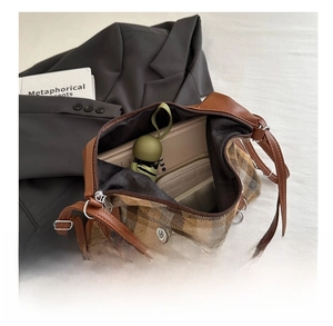 Interior view showing the capacity of the brown plaid crossbody bag with daily essentials