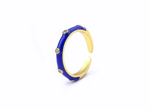 Detail of 18K gold-plated ring with blue enamel inlay and sparkling cubic zirconia stones