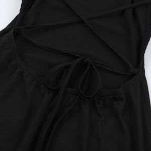 Close-up of sexy backless dress featuring intricate criss-cross lace-up straps on black fabric