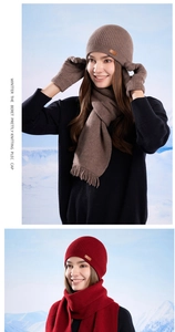Detail of winter knitted hat, scarf and gloves set with leather patch and tassel finish