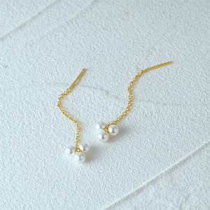 Detail of S925 silver gold chain earrings featuring a cluster of three white pearls