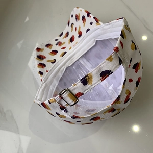 Detailed view of the colorful abstract print baseball cap with a bronze metal adjuster