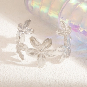 Macro shot of silver cherry blossom open bangle with delicate floral petal design details