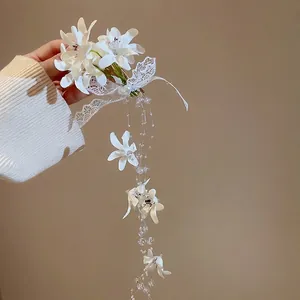Elegant white fabric flower hair clip with long lace ribbons and pearl tassel fringe
