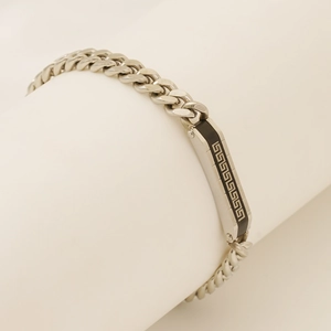 Close-up of Cuban chain bracelet for men with Greek meander pattern and black inlay