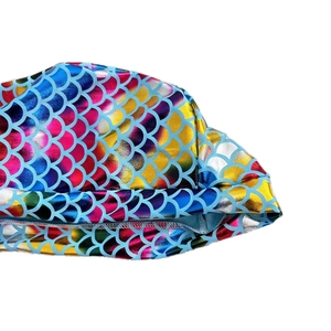 Macro view of metallic rainbow fish scale texture on the cycling bandana fabric