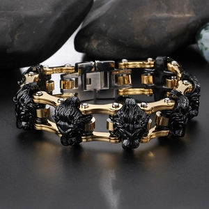 Macro shot of stainless steel lion head bracelet with black and gold mechanical chain