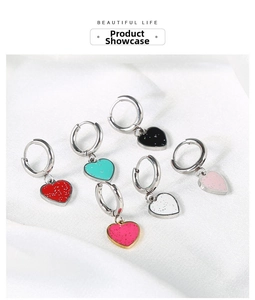 Detailed flat lay of heart charm hoop earrings in six vibrant colors with glitter finish