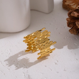 Abstract geometric open ring with golden lava texture on a minimalist white stone background