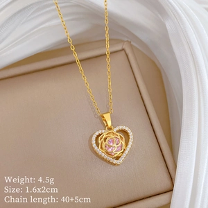 Detail of gold heart pendant necklace with pink rose and sparkling zircon crystals