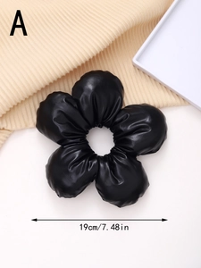 Detail of a black leather floral hair tie showing 19cm/7.48in diameter measurement