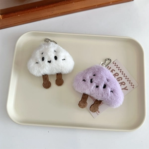 Detail of plush cloud pendants in white and lavender with metal bead chains for bags