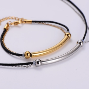 Minimalist gold and silver curved tube bracelets with black braided cord and metal chains