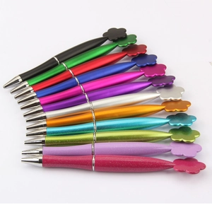 Detail shot of eleven colorful flower-topped pens with glitter and metallic finishes