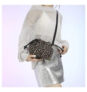 Detail showing leopard print texture with drawstring closure and metal reinforced corners