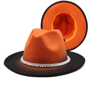 Detail of two-tone gradient wool fedora with pearl band and wide brim design