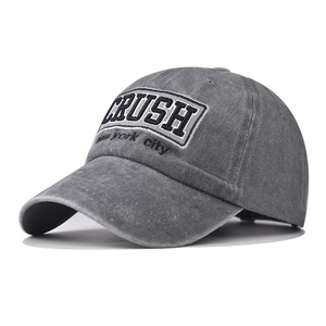 Detail of CRUSH embroidery on dark grey washed cotton vintage baseball cap