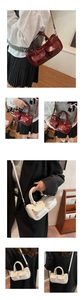 Detail view of glossy retro saddle bag with double pockets and adjustable metal strap buckle