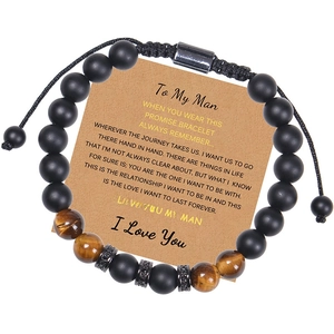 Detail of tiger eye bead bracelet with engraved metal spacers on a gift message card