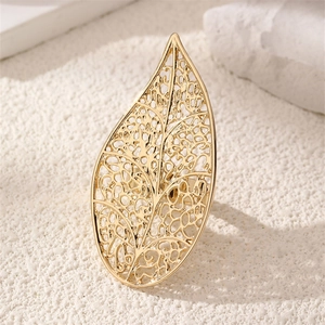 Macro view of detailed hollow leaf pattern and gold texture on this statement ring