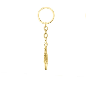 Detailed view of a shiny golden metal keychain with lobster clasp and elegant fringe tassel