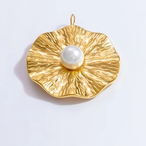 Macro shot of gold-plated wavy texture pendant featuring a central white pearl inlay