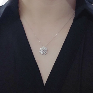 Silver camellia flower pendant necklace with shimmering crystals on a fine chain