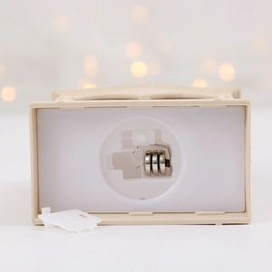 Close-up of bottom battery compartment with three button cells for decorative lantern