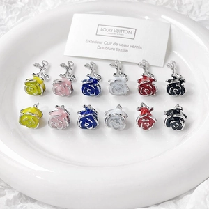 Detailed view of colorful enamel rose charms for DIY jewelry making in six vibrant colors