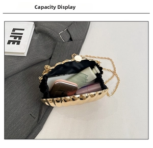 Internal view of gold shell clutch bag showing space for phone and makeup accessories