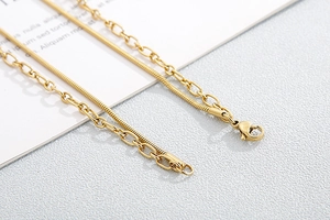 Detail view of double-layer gold snake and link chains with heart padlock pendant