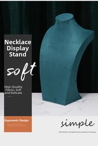 Macro detail of dark green velvet necklace bust stand with ergonomic neck display profile