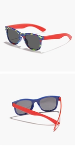 Detail of blue dinosaur print kids sunglasses showing front frame and red temples
