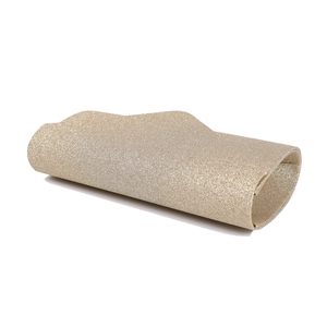 Close-up of golden glitter evening clutch bag with elegant curved flap envelope design