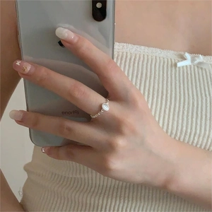 Detailed view of silver chain ring featuring an oval cat eye stone on hand