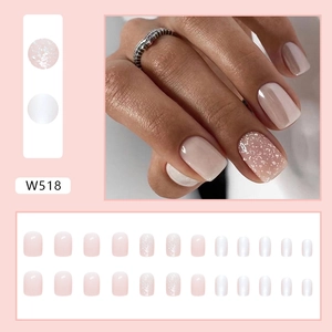 Detail of W518 nude pink press-on nails set with glitter accents in 24 pieces