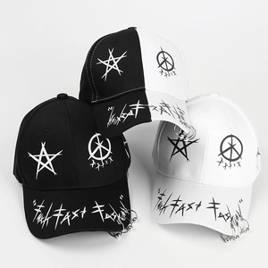 Close-up of punk baseball caps with metal rings and street graffiti star prints