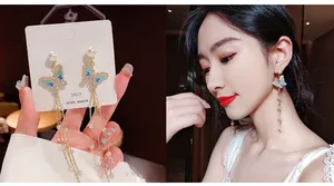 Detail view of S925 silver needle butterfly tassel earrings with blue gradient wings