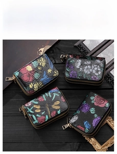 Détail de portefeuilles en cuir embossé avec motifs floraux et libellules sur bois