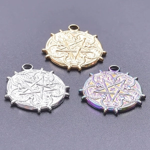 Macro detail of goat head pentagram charms in gold, silver, and iridescent finishes