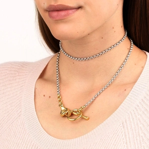 Minimalist silver and gold dual-layer necklace with OT buckle on pink background