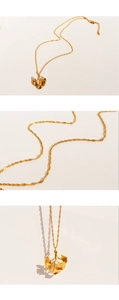 Detailed close-up showing the intricate texture of the golden ginkgo leaf pendant and chain