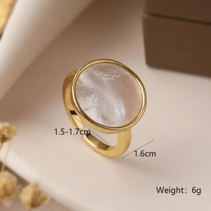Detail view of gold geometric ring featuring white shell inlay and adjustable band