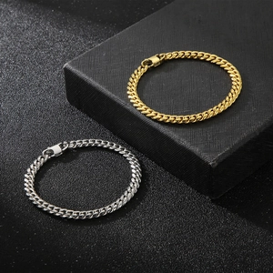 Polished gold and silver titanium steel Cuban link chain bracelets on black background