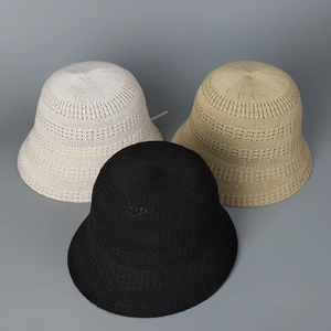 Detail of three knitted hollow bucket hats in beige, khaki and black with mesh texture