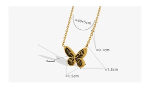 Detail view of gold butterfly pendant with black enamel dripping and size specifications